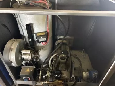 Internal view of Nilfisk SH Truck Booster cabinet before servicing, showing components prior to cleaning and maintenance.